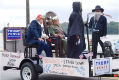 Float depicts Trump throwing switch on Clinton in electric chair; Obama as Easter Island figure in black face.
